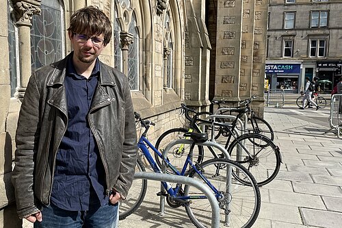 Jack Caldwell standing in front of bike racks