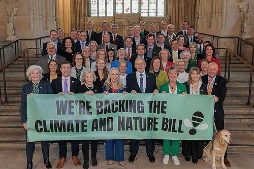 MPs in Parliament holding Climate and Nature Banner 