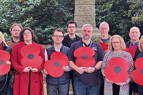 Cllrs and others holding large poppies 