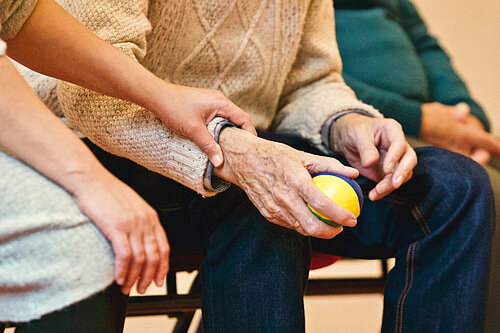 Older people holding hands 