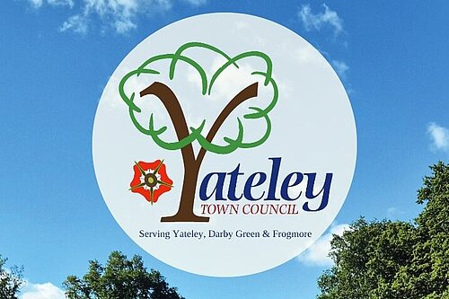 Yateley Town Council Crest against a blue sky