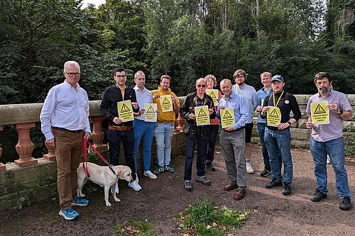 Tim, Peter and other Lib Dem campaigners holding pollution warning signs