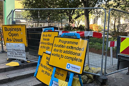 The incomplete works at Hay Hill. There is a yellow sign pointing out that the programme duration has been extended.